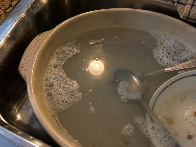 A lamp reflected like a moon in dishwater